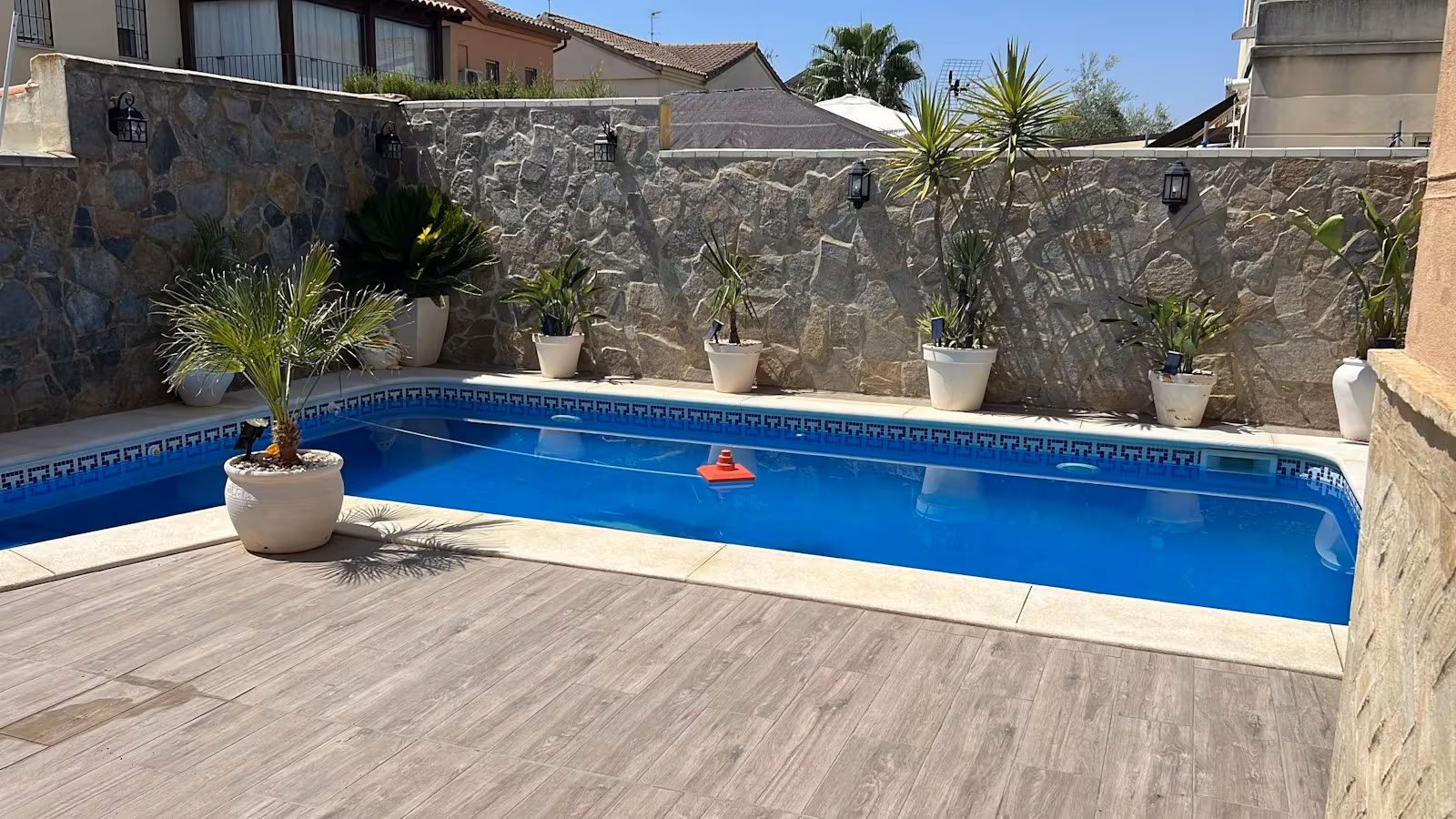 Pool alongside a stacked-stone wall